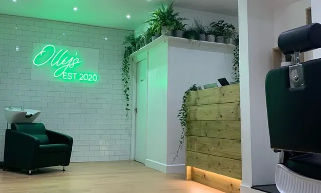 The neon sign and plants at Olly's